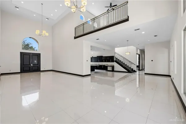 a view of a livingroom with furniture and a hallway