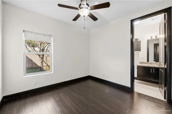 a view of a hallway with wooden floor
