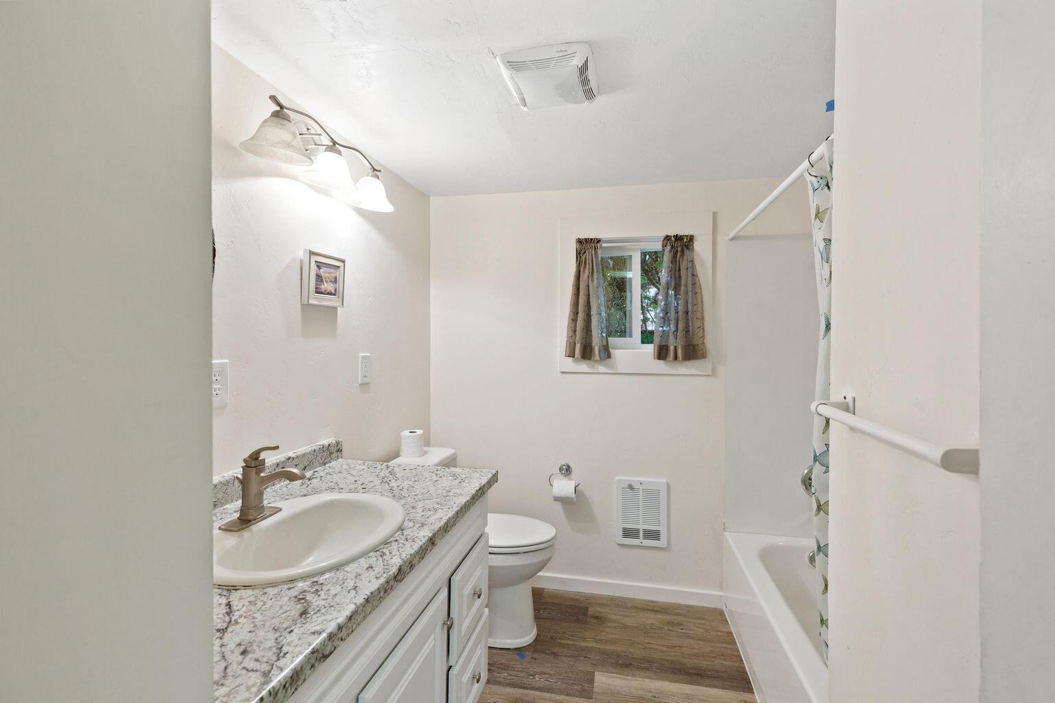 4601 Lower River Road Grants Pass, OR 97526 - Photo 20 of 36 a bathroom with a granite countertop sink toilet and shower