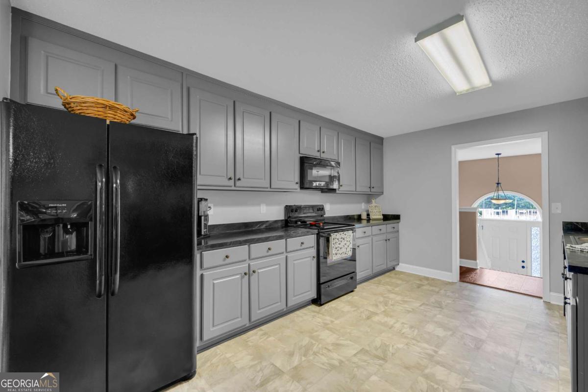 335 Elizabeth Court Colbert, GA 30628 - Photo 11 of 33 a kitchen with stainless steel appliances granite countertop a refrigerator a stove and a sink