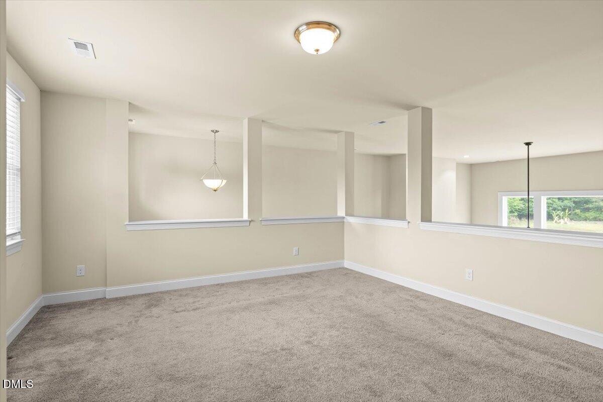 704 Haw River Hopedale Road Burlington, NC 27217 - Photo 28 of 49 an empty room with a empty space and windows