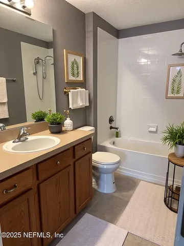 a bathroom with a sink a toilet and a large mirror
