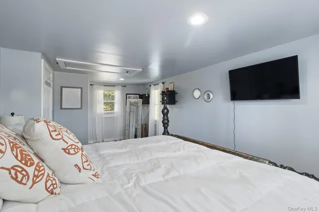 a bed room with a bed and a television