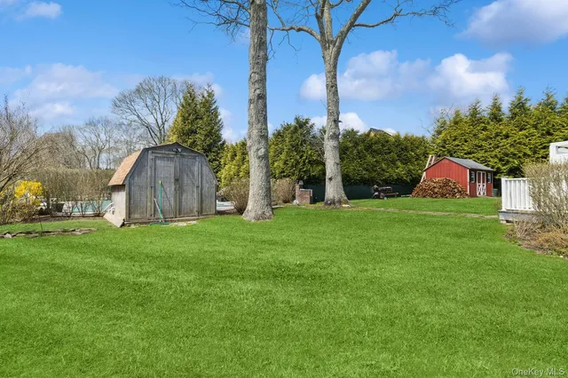 a view of a house with a yard and sitting area