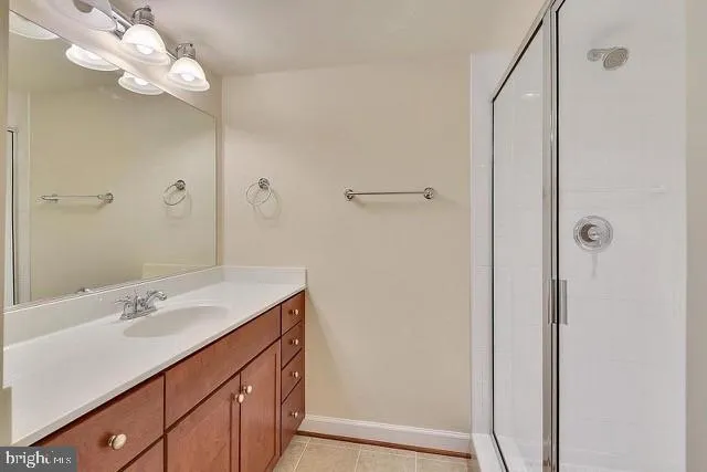 a bathroom with a sink a mirror and a shower
