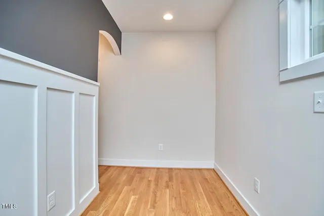 a view of a small space with wooden floor and a window