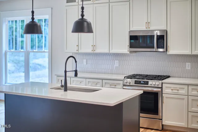 a kitchen with a stove and a sink