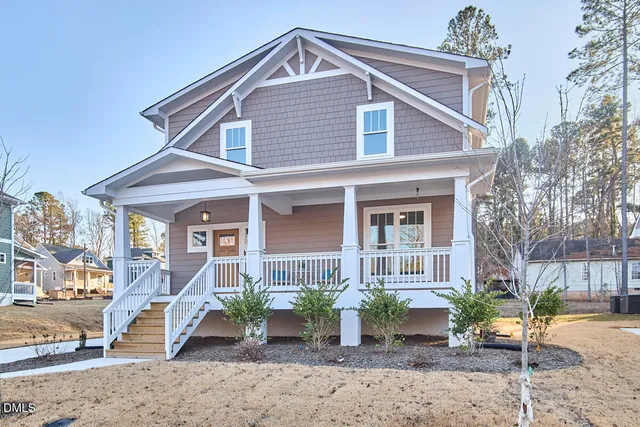 a living room with furniture a fireplace and a window