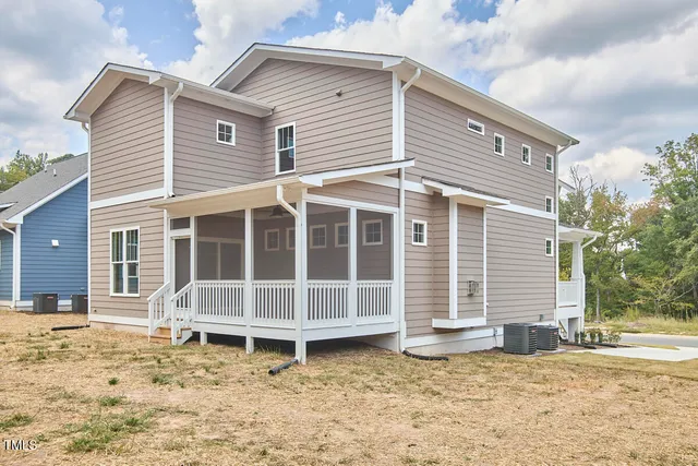 a white house with a large window and wooden fence
