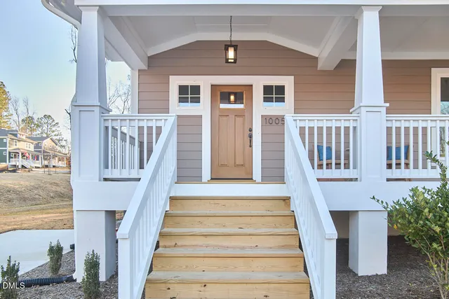 a living room with furniture kitchen view and a window