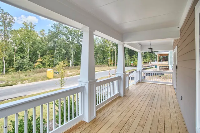 a view of a porch with wooden floor and outdoor space