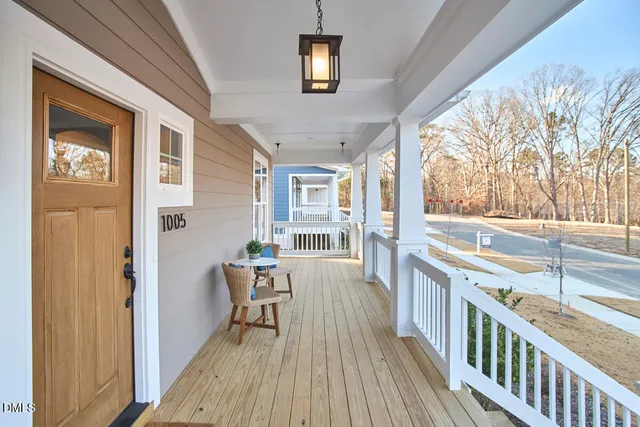 a view of a dining room with furniture wooden floor and a chandelier
