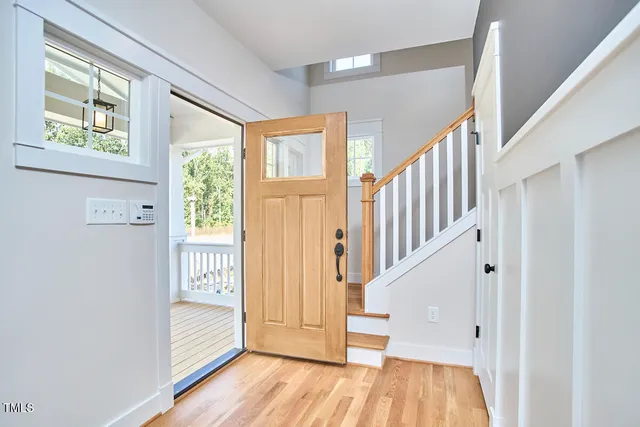 a view of entryway with wooden floor and stair