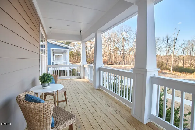 a view of a dining room with furniture a chandelier and wooden floor