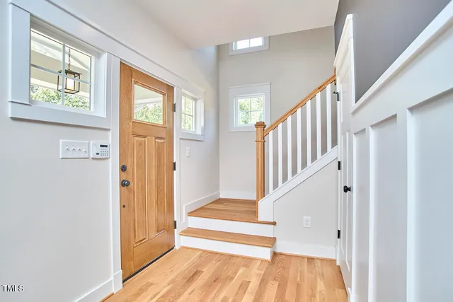a view of entryway and hall with wooden floor