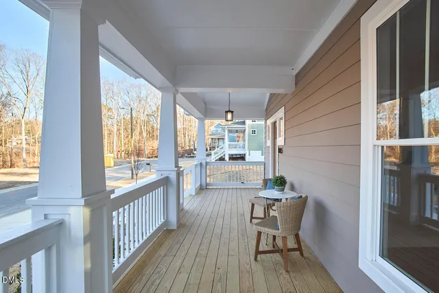 a dining room with furniture a chandelier and wooden floor