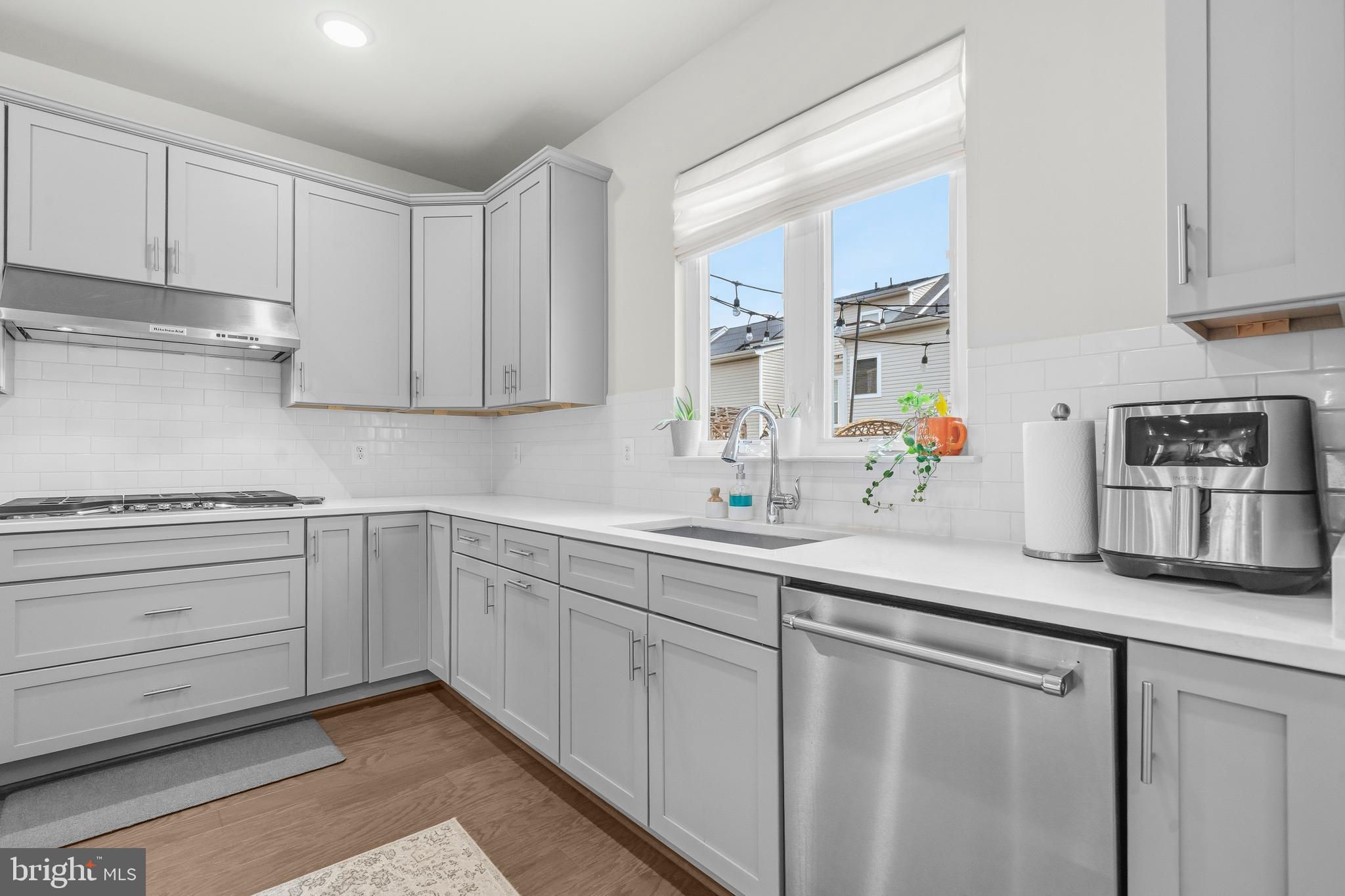 7715 Cresap Lane Hanover, MD 21076 - Photo 14 of 42 a kitchen with white cabinets and white appliances