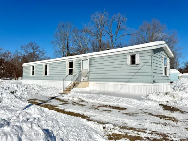 a front view of a house with a yard covered in snow