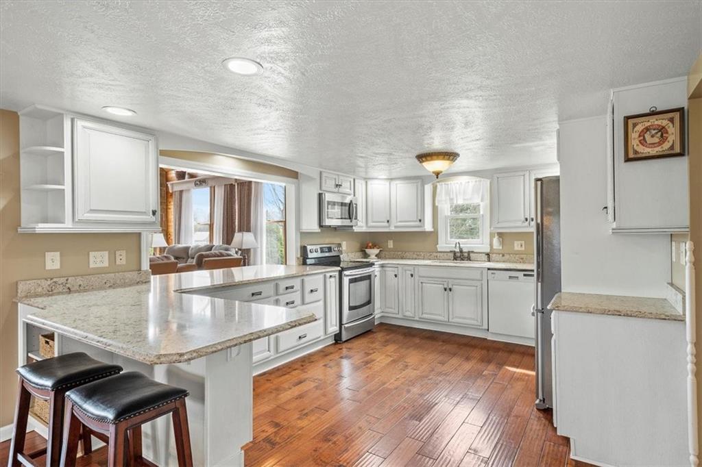 2510 South Bridge Road Washington, PA 15301 - Photo 7 of 25 a large kitchen with cabinets wooden floor and stainless steel appliances