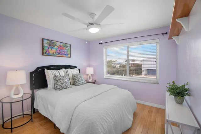 a bedroom with a large bed and a potted plant
