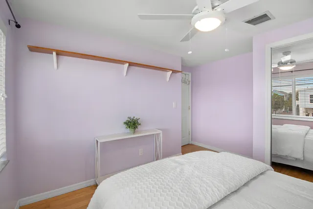 a bedroom with a bed and a potted plant