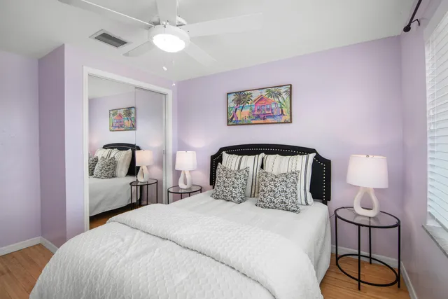 a bedroom with a bed and lamp