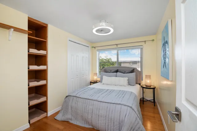 a bedroom with a bed and a window