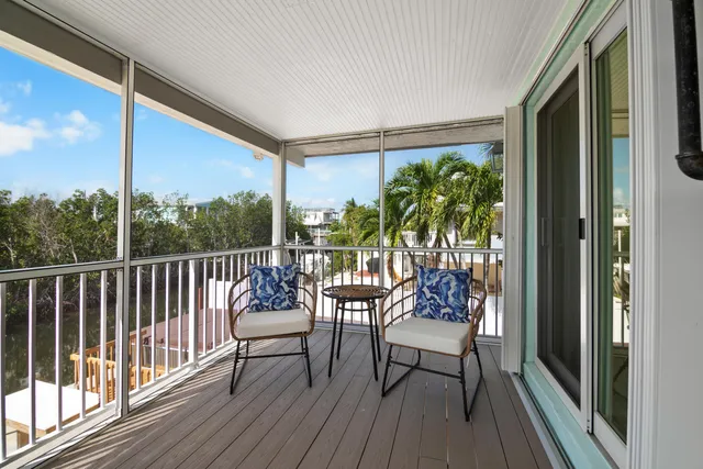 a view of balcony with chair and wooden floor