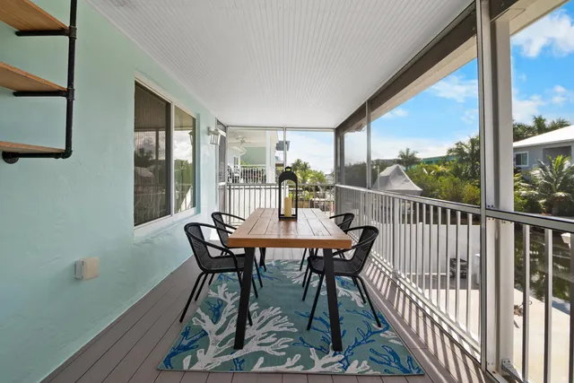 a view of a balcony dining table and chairs