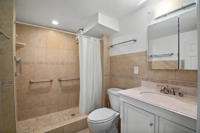 a bathroom with a sink toilet and shower