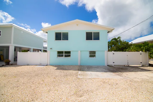 an aerial view of a house with swimming pool patio and outdoor seating