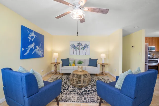 a living room with furniture and a chandelier