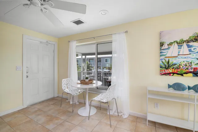 a dining room with furniture and a window
