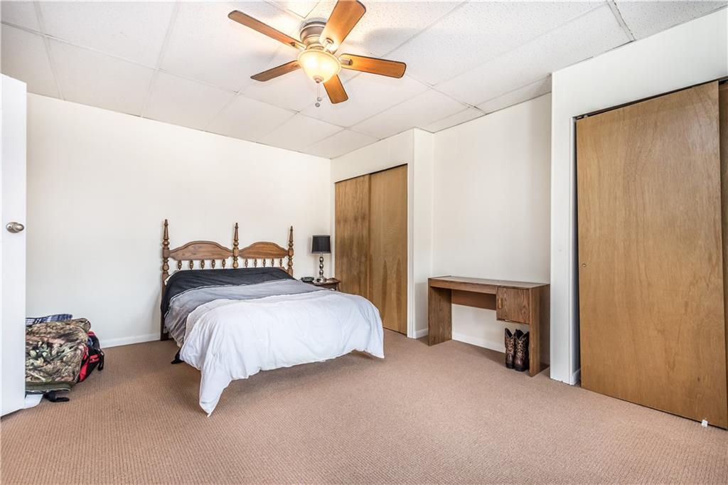 1549 McFarland Road Pittsburgh, PA 15216 - Photo 14 of 25 a bedroom with a bed and a chandelier