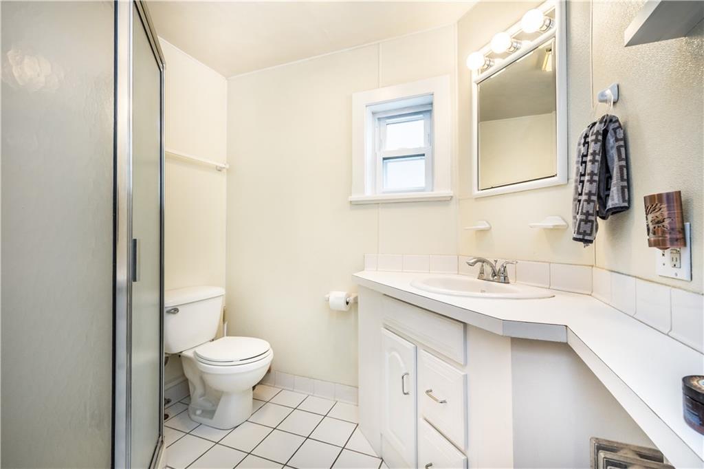 1549 McFarland Road Pittsburgh, PA 15216 - Photo 15 of 25 a bathroom with a sink toilet and mirror