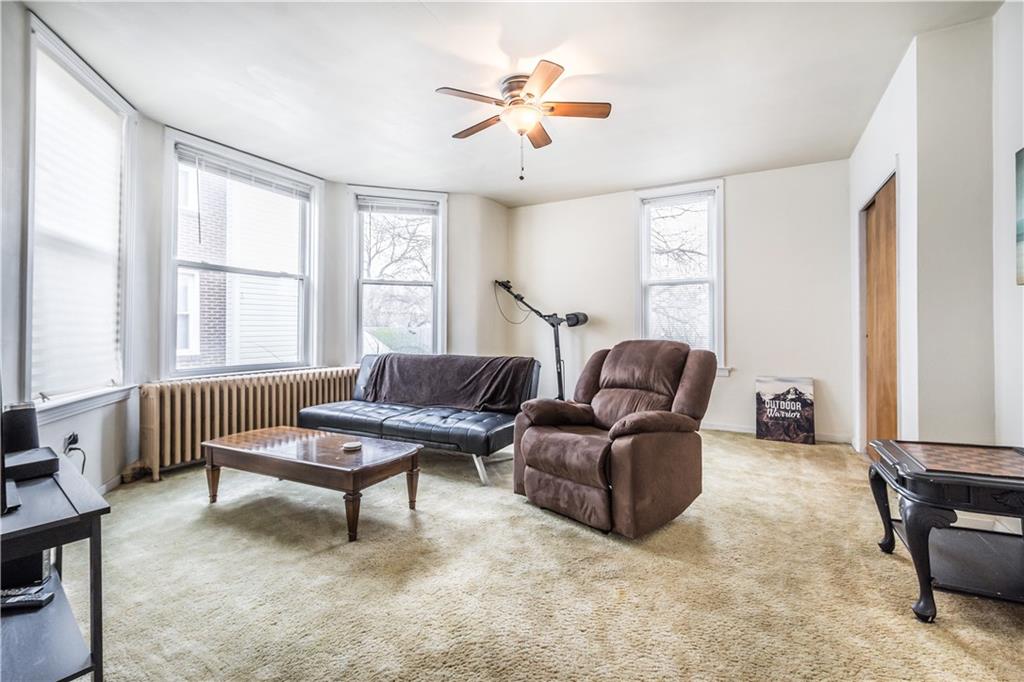 1549 McFarland Road Pittsburgh, PA 15216 - Photo 16 of 25 a living room with furniture and a window