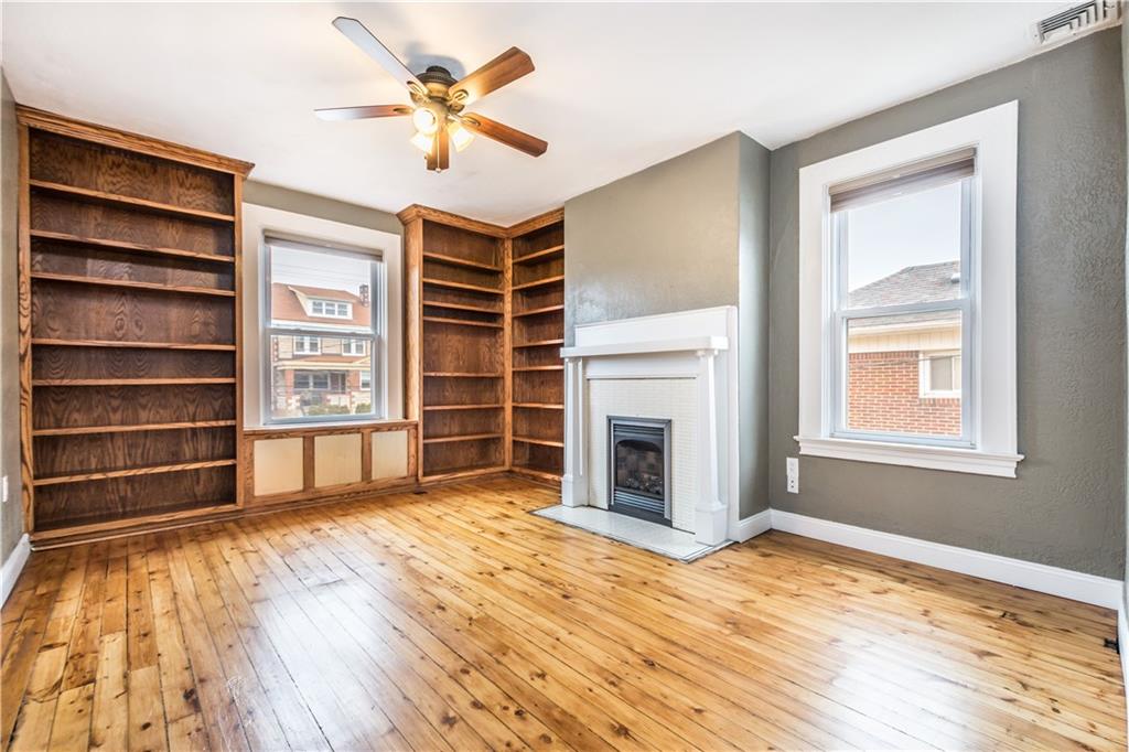 1549 McFarland Road Pittsburgh, PA 15216 - Photo 7 of 25 a view of an empty room with a fireplace and a window