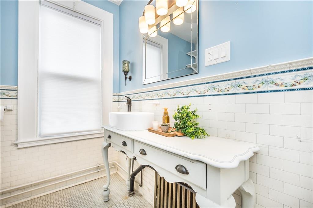 1549 McFarland Road Pittsburgh, PA 15216 - Photo 9 of 25 a bathroom with a sink and a mirror