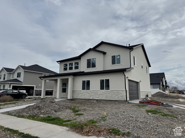 593 West 250 North Springville, UT 84663 - Photo 1 of 1 View of front of property with stone siding, a garage, and stucco siding
