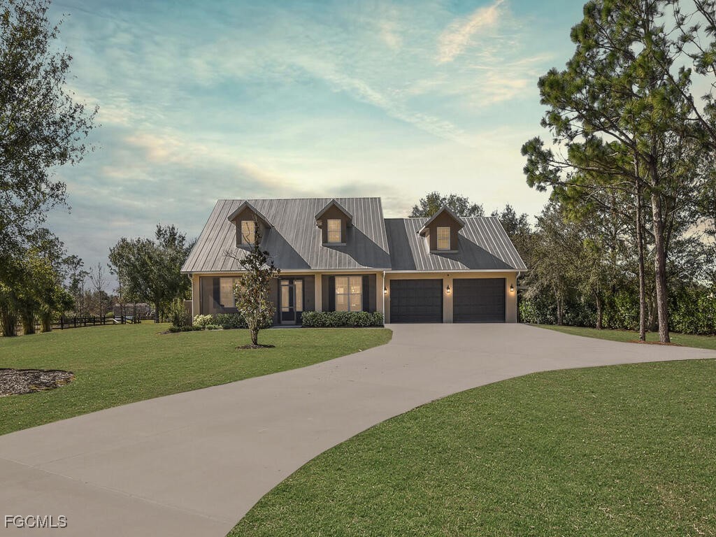 a front view of house with yard and green space