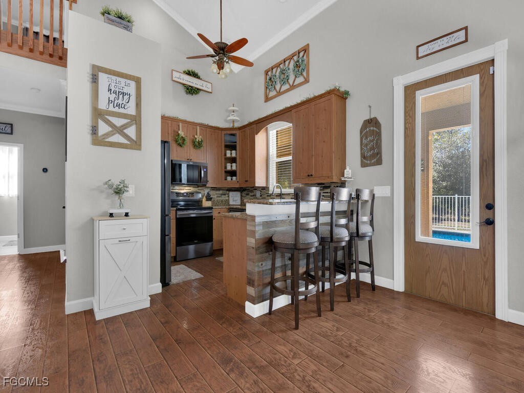 6041 Alan Boulevard Punta Gorda, FL 33982 - Photo 15 of 44 a view of a dining room kitchen with furniture window and wooden floor