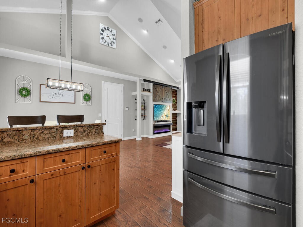 6041 Alan Boulevard Punta Gorda, FL 33982 - Photo 17 of 44 a kitchen with kitchen island granite countertop stainless steel appliances and counter space