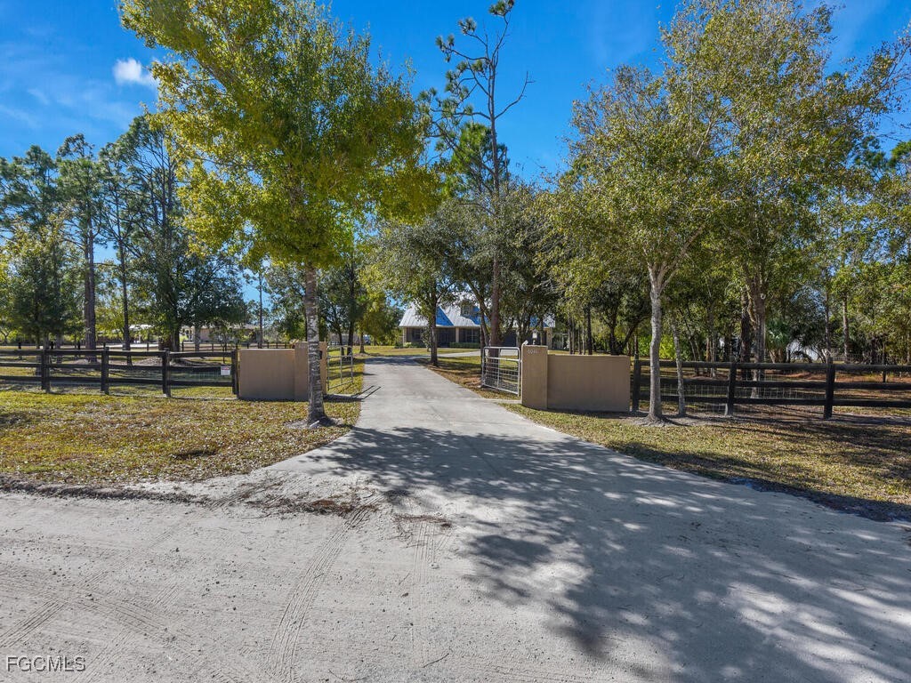 6041 Alan Boulevard Punta Gorda, FL 33982 - Photo 2 of 44 a backyard of a house with a swing and slide