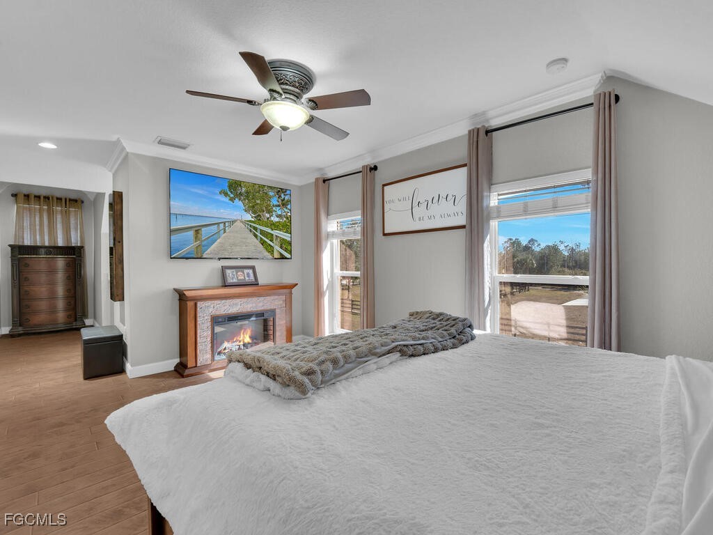 6041 Alan Boulevard Punta Gorda, FL 33982 - Photo 22 of 44 a bedroom with a bed dresser and a large window