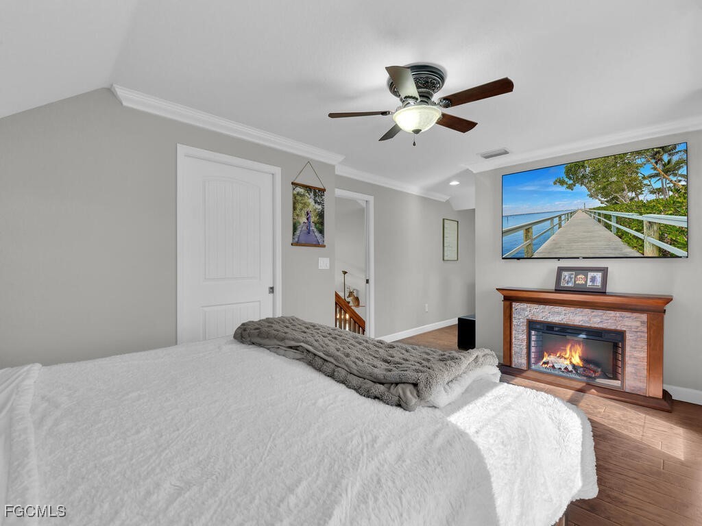 6041 Alan Boulevard Punta Gorda, FL 33982 - Photo 23 of 44 a bedroom with a bed and a fireplace