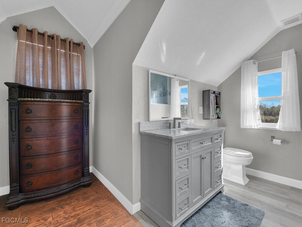 6041 Alan Boulevard Punta Gorda, FL 33982 - Photo 24 of 44 a bathroom with a granite countertop sink toilet and shower
