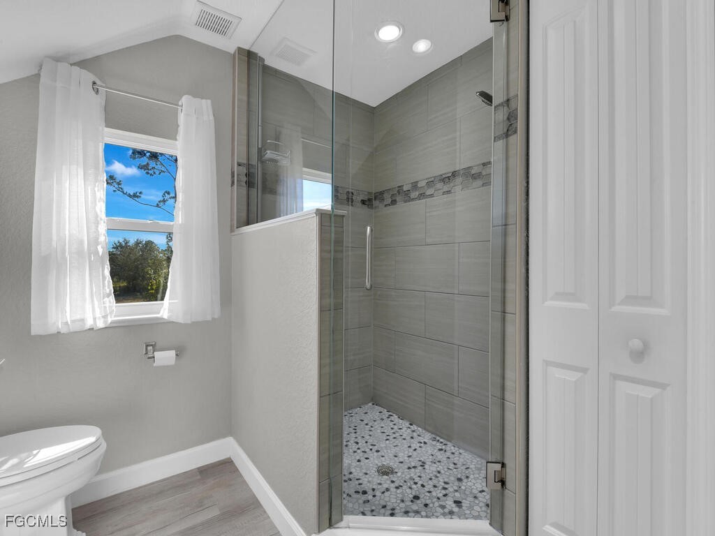 6041 Alan Boulevard Punta Gorda, FL 33982 - Photo 26 of 44 a bathroom with a shower and a toilet