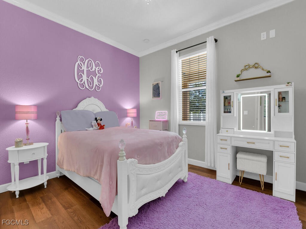 6041 Alan Boulevard Punta Gorda, FL 33982 - Photo 27 of 44 a bedroom with a bed and wooden floor