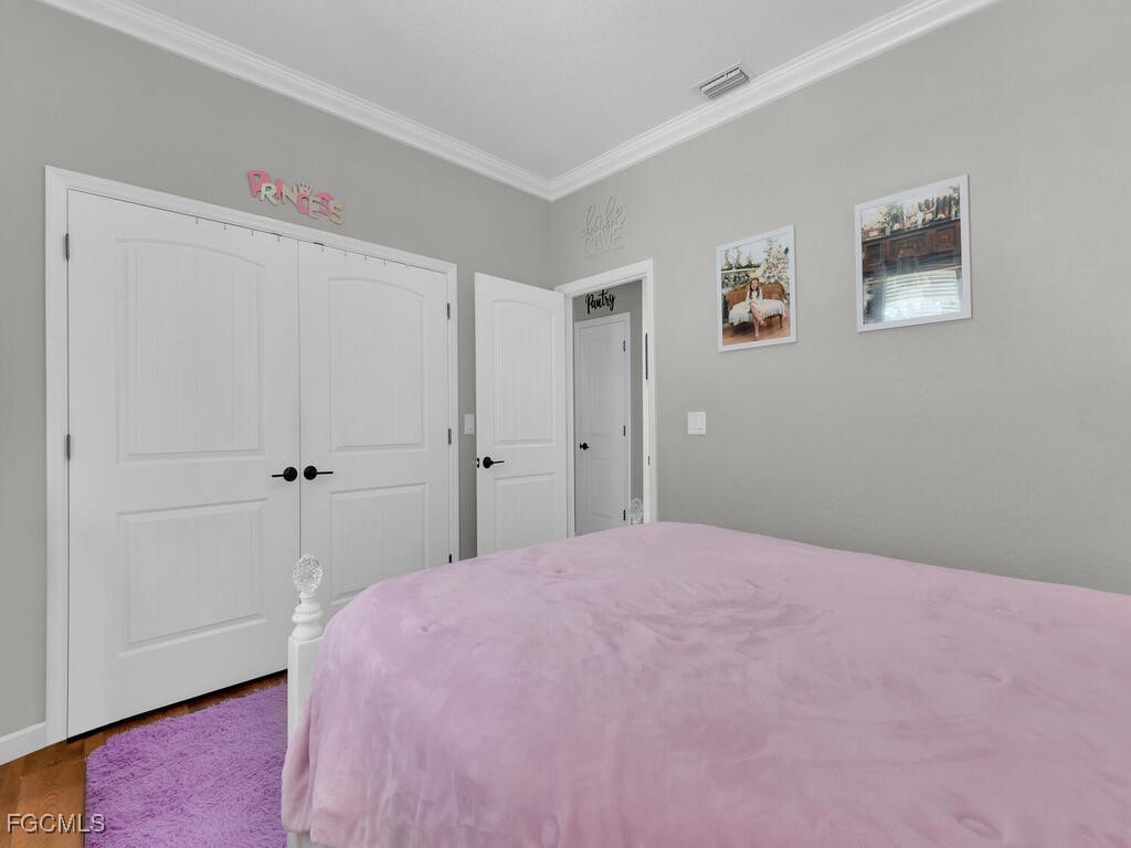 6041 Alan Boulevard Punta Gorda, FL 33982 - Photo 28 of 44 a bedroom with a bed and a window