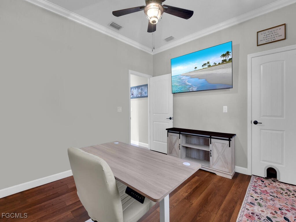 6041 Alan Boulevard Punta Gorda, FL 33982 - Photo 31 of 44 a bedroom with a bed and a chandelier